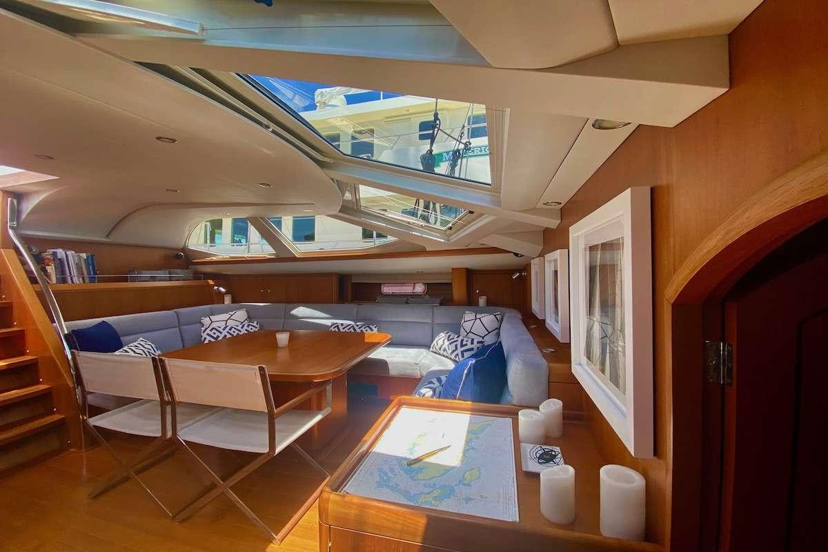 a room with a couch and a table aboard AEGIS Yacht for Charter