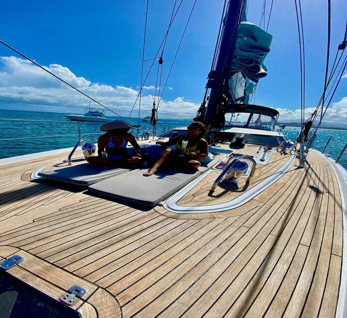 a couple of men on a sailboat on the water aboard AEGIS Yacht for Charter