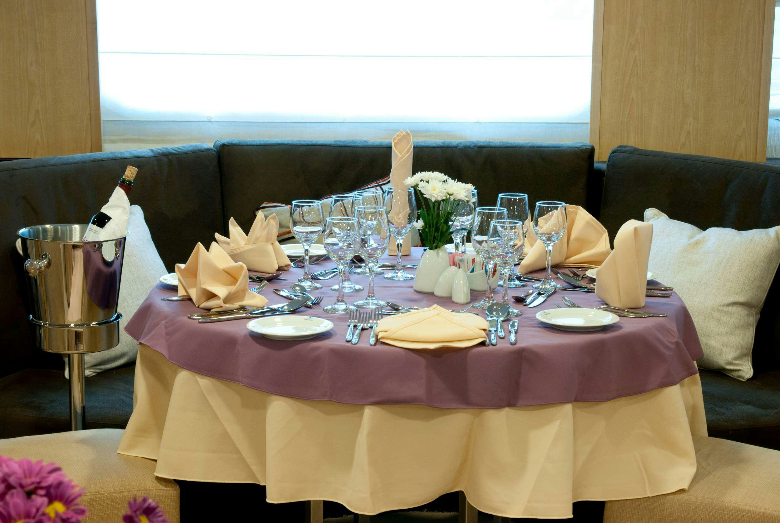a table set with food and wine aboard HARMONY V Yacht for Charter