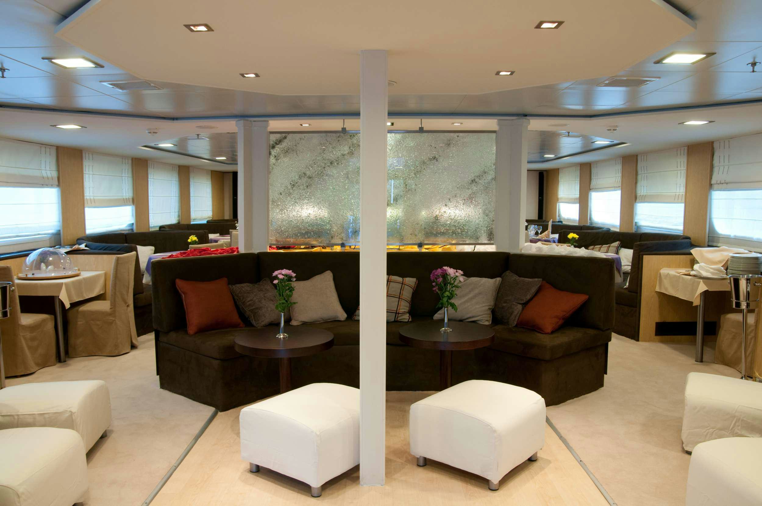 a large room with couches and tables aboard HARMONY V Yacht for Charter