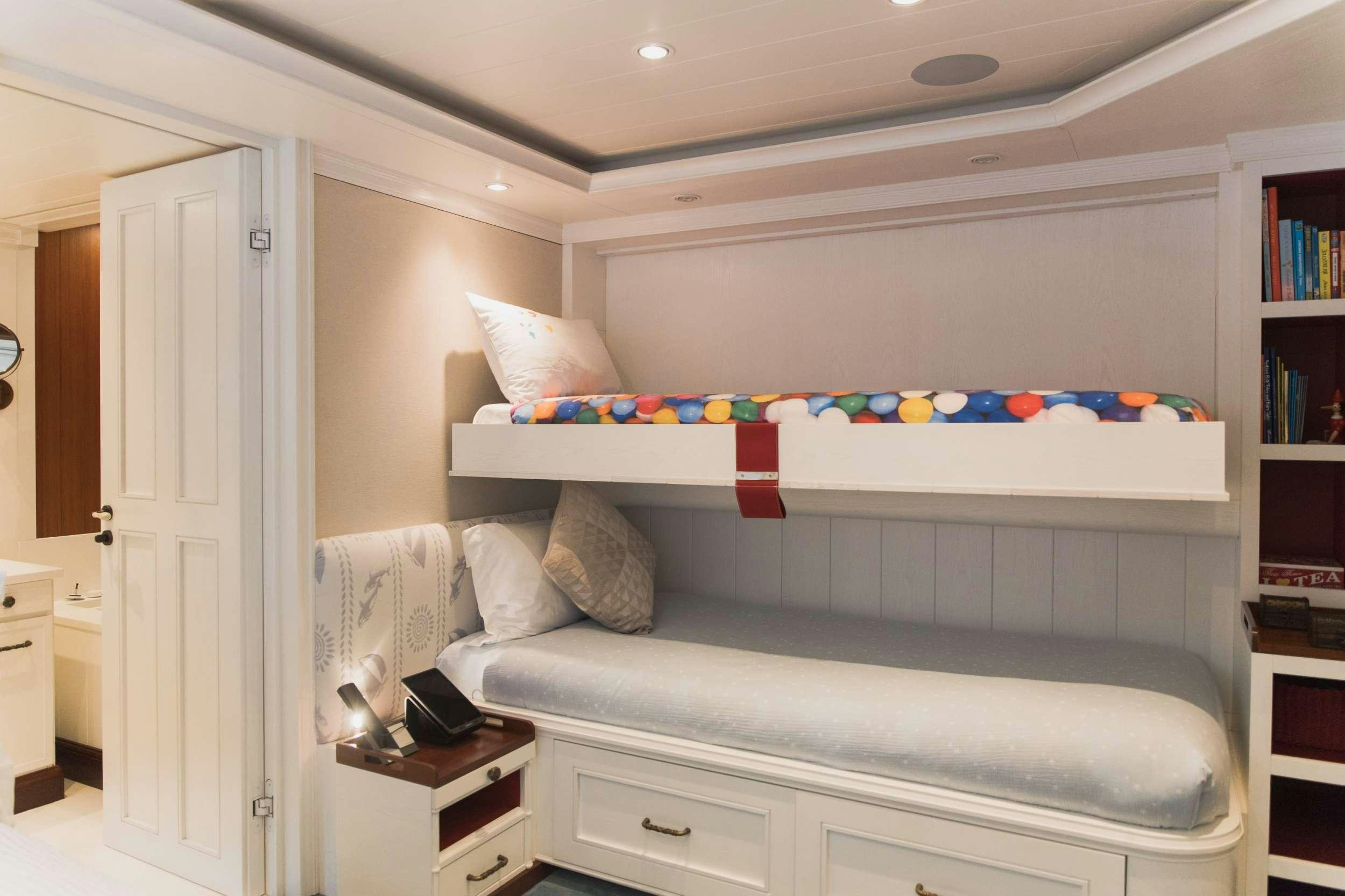 a bed with a white bed spread aboard LADY TRUDY Yacht for Charter