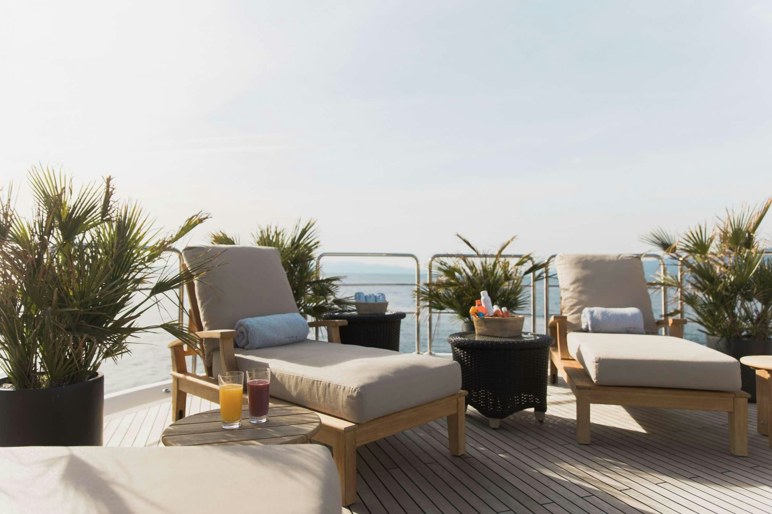 a room with a table chairs and plants aboard LADY TRUDY Yacht for Charter