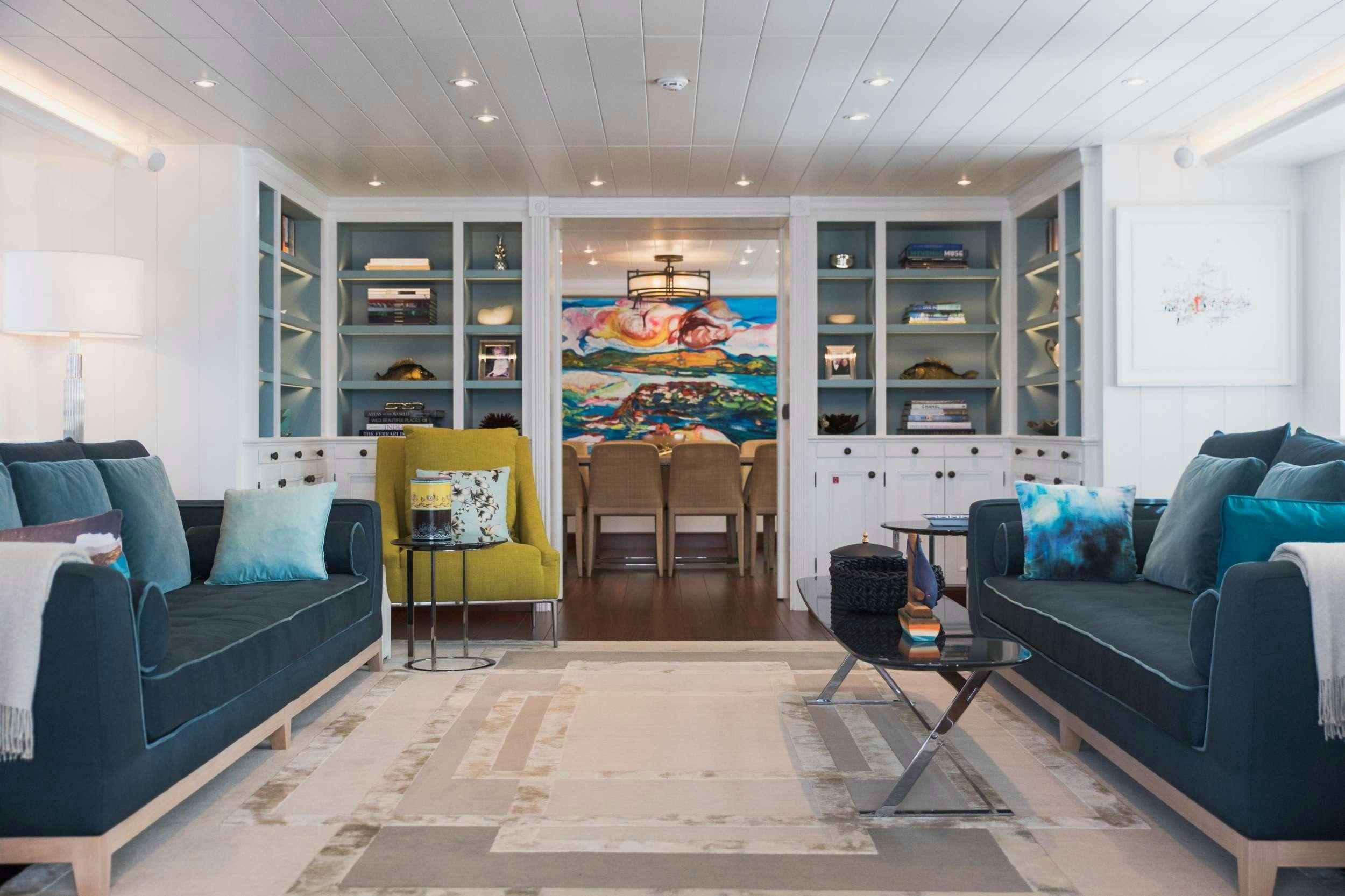 a living room with blue couches aboard LADY TRUDY Yacht for Charter