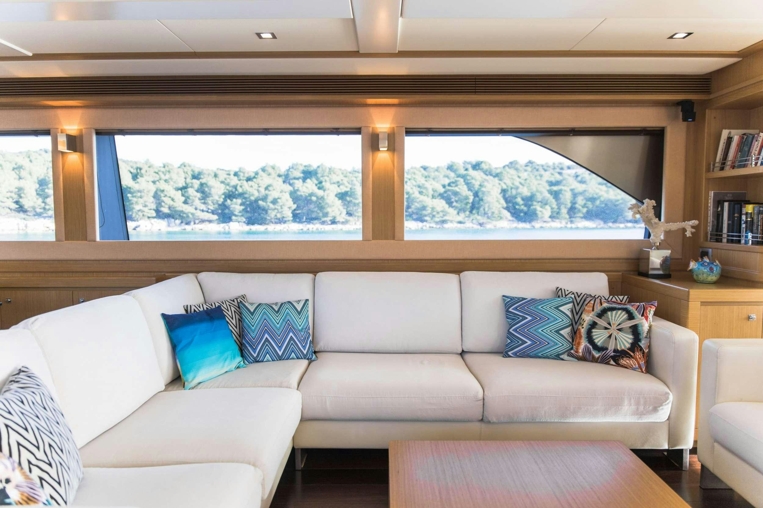 a couch with pillows in a room aboard FRIEND'S BOAT Yacht for Charter