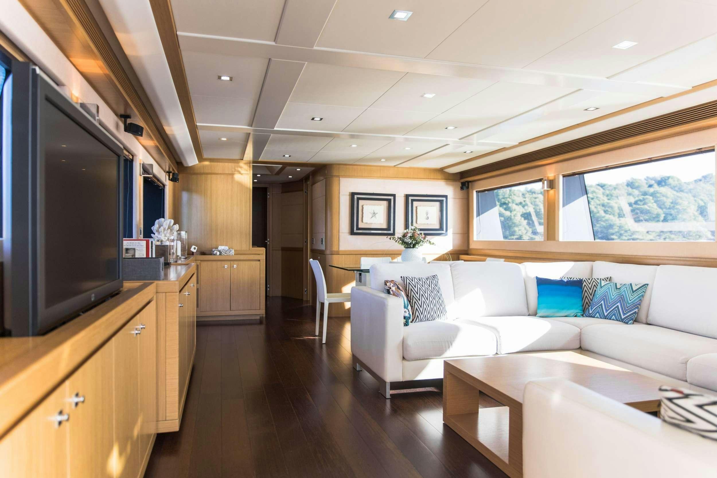 a living room with a couch and a tv aboard FRIEND'S BOAT Yacht for Charter