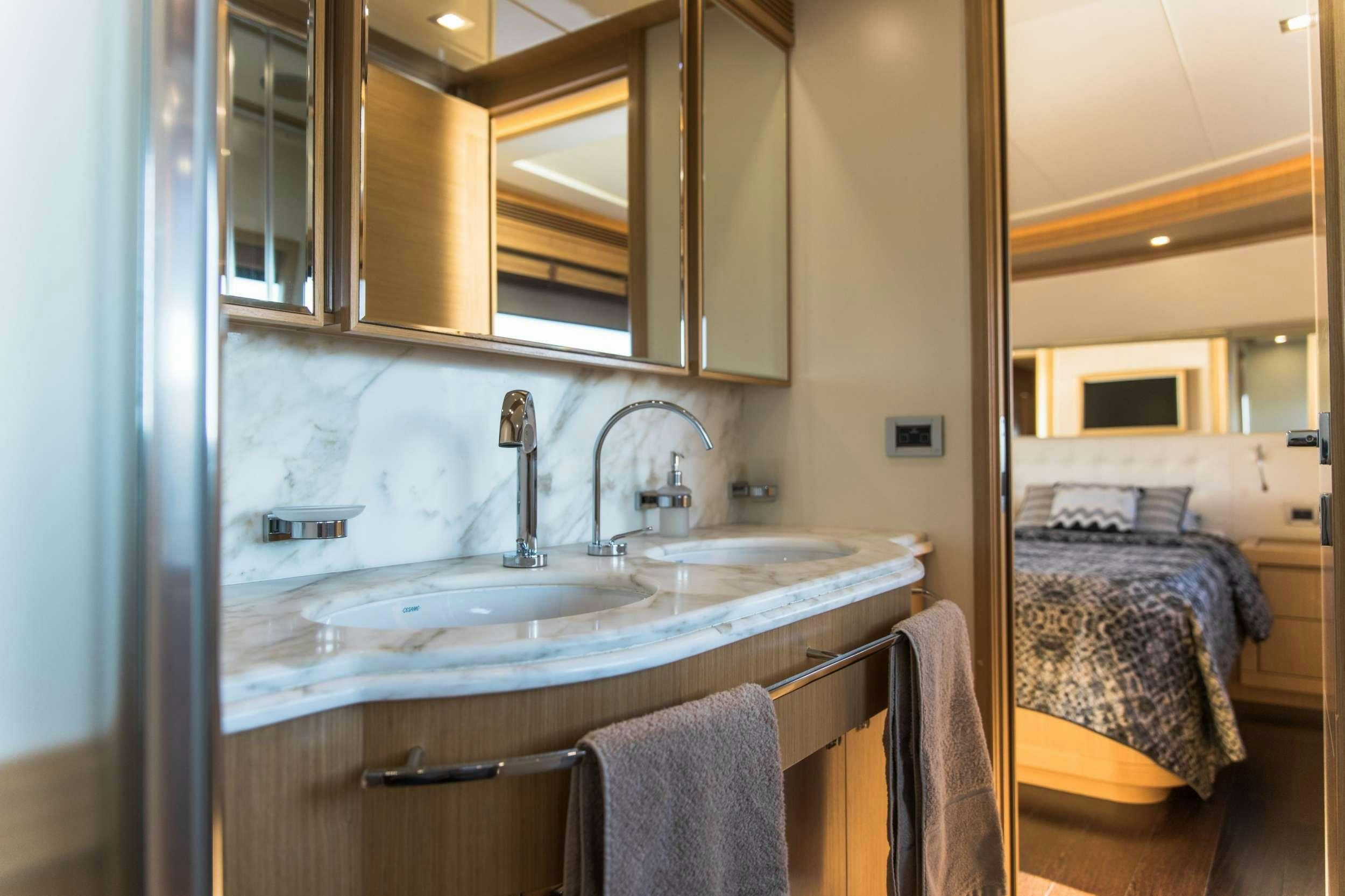 a bathroom with a sink and a bed aboard FRIEND'S BOAT Yacht for Charter