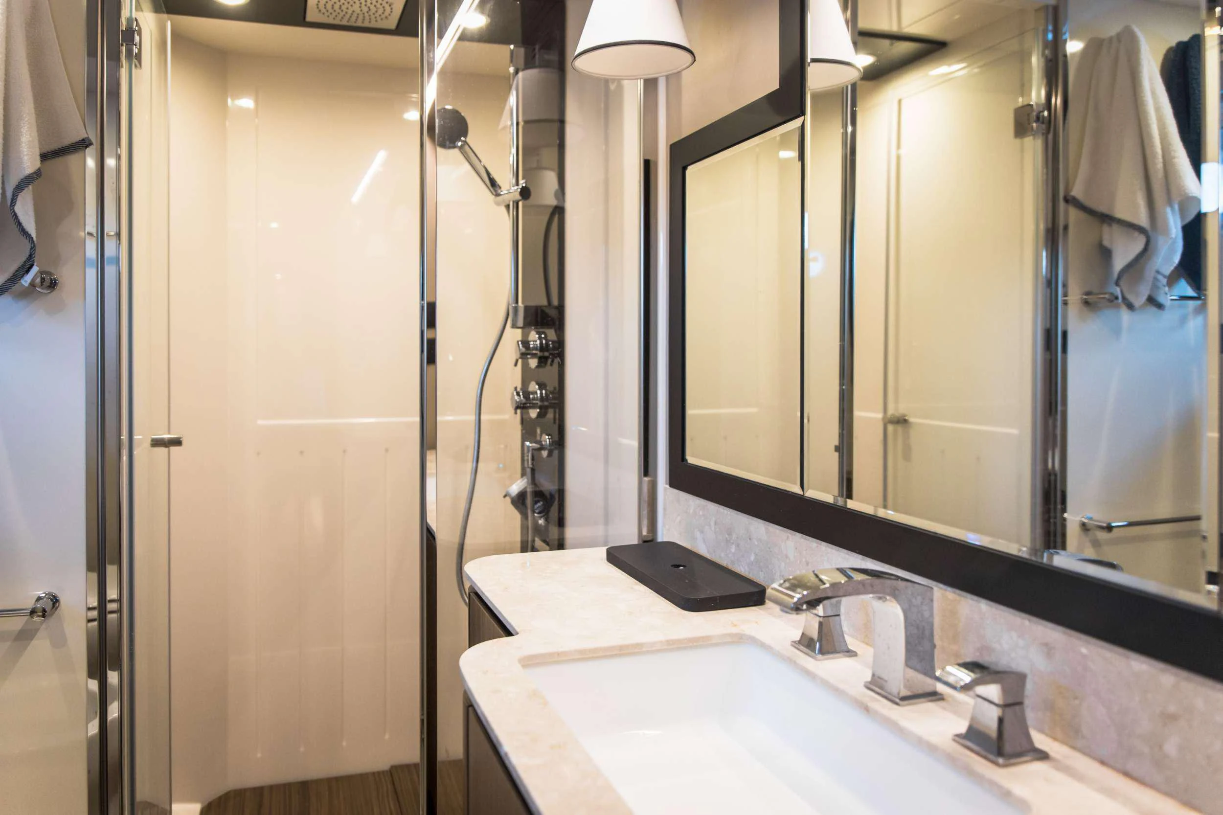 a bathroom with a sink and a mirror aboard BOLLINGER Yacht for Charter