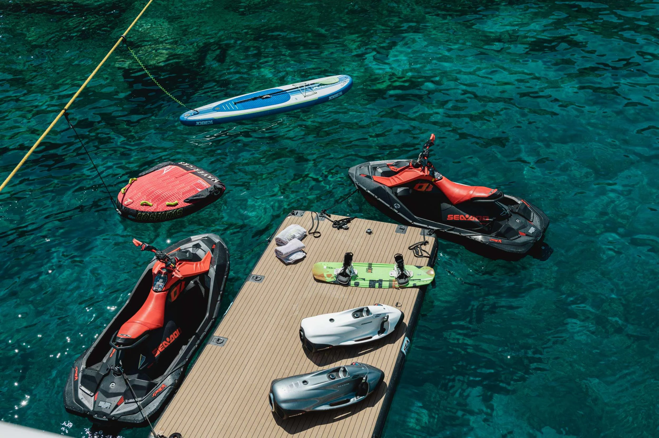 a group of kayaks on a body of water aboard LOANA Yacht for Charter