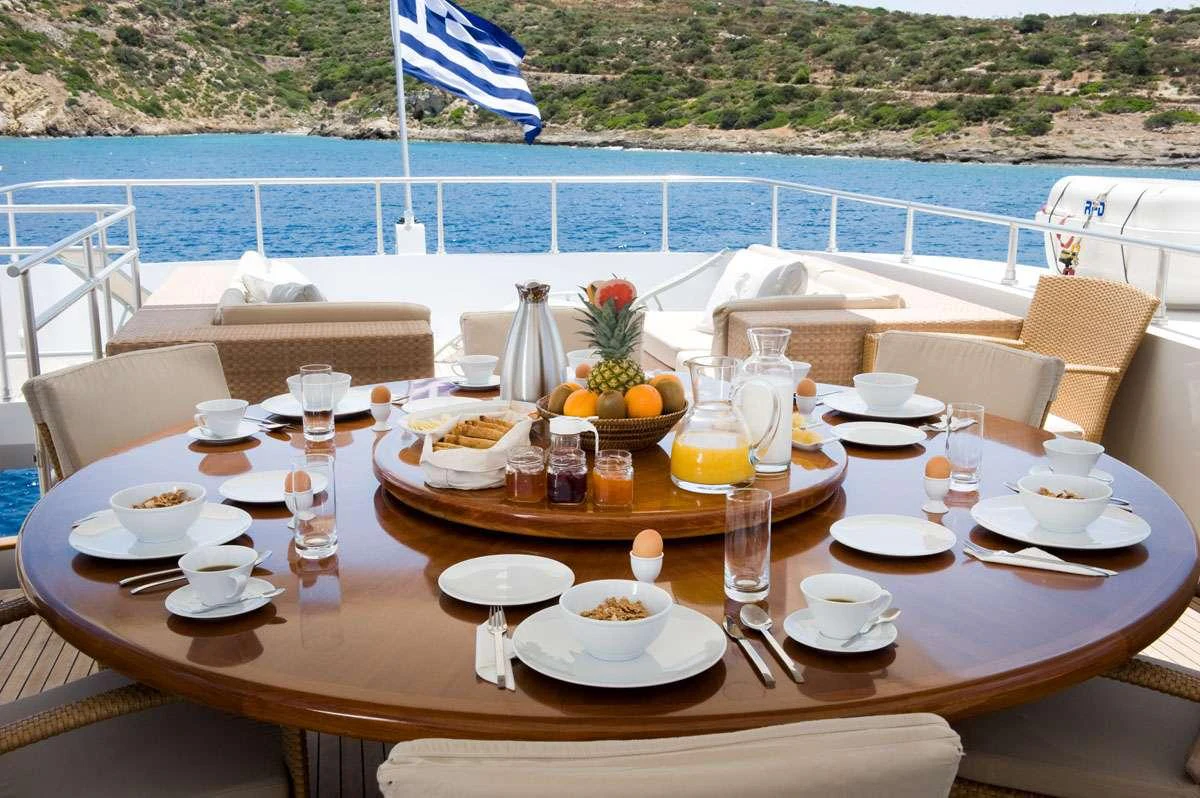 a table with food and drinks on it aboard LOANA Yacht for Charter