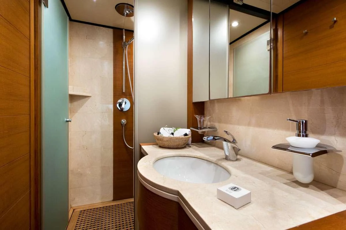 a bathroom with a sink and a mirror aboard LOANA Yacht for Charter