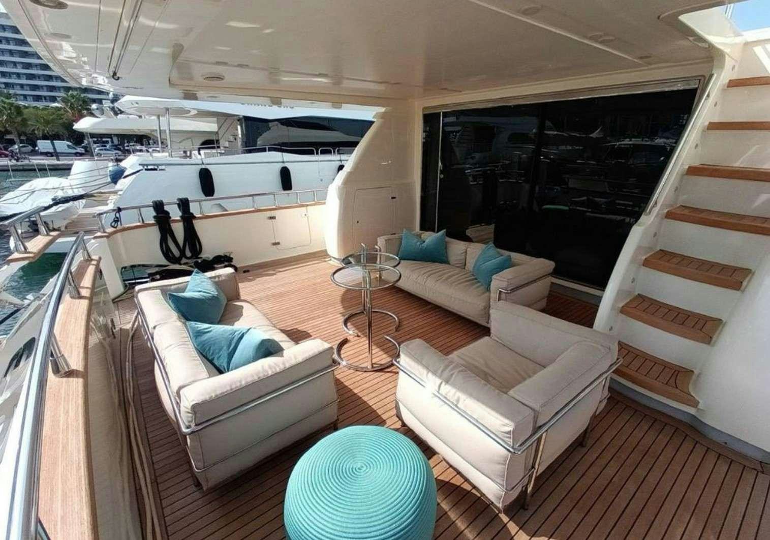 a living room with a large white sofa and a white table aboard MIRAVAL Yacht for Charter