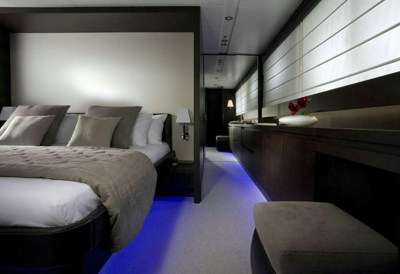 a room with a bed and a desk aboard MIRAVAL Yacht for Charter