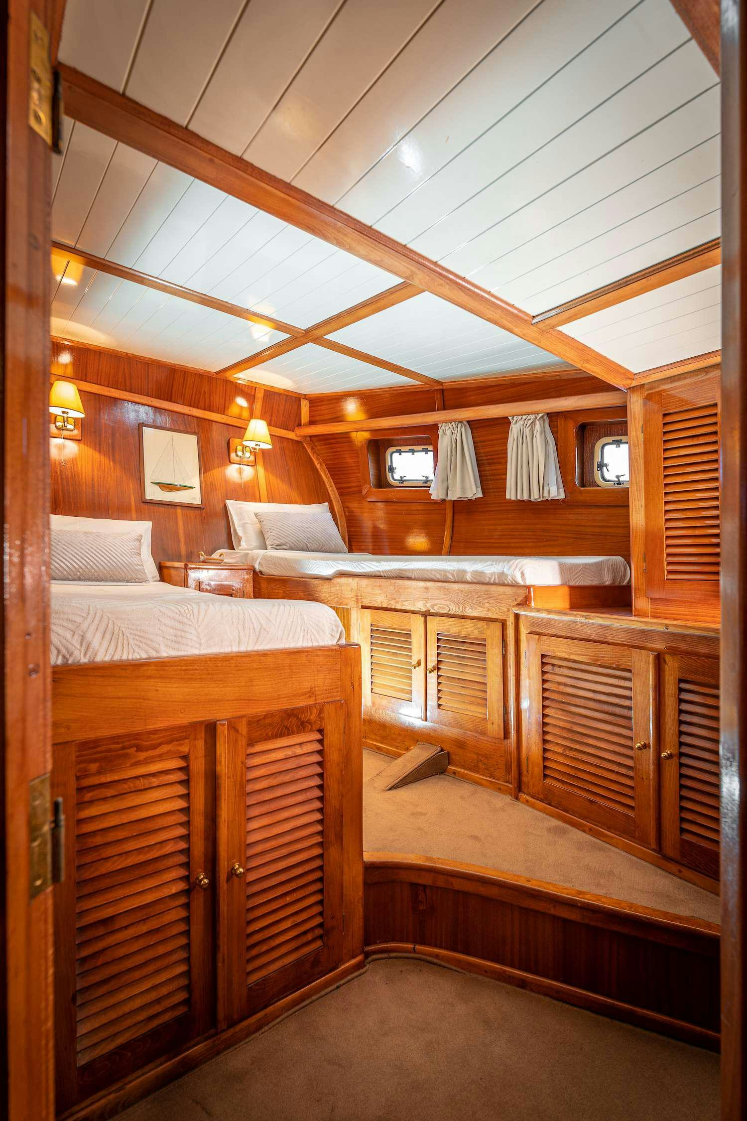 a room with wooden bunk beds aboard MYRA Yacht for Charter