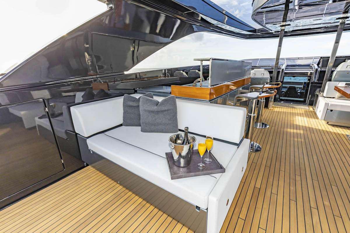 a boat with a table and chairs aboard TASTY WAVES Yacht for Charter