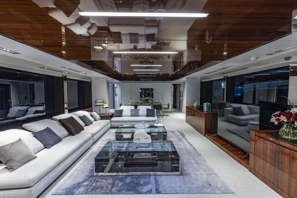 a living room with a large glass table and a large window aboard TASTY WAVES Yacht for Charter