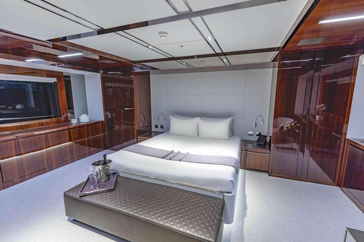 a room with a bed and a television aboard TASTY WAVES Yacht for Charter