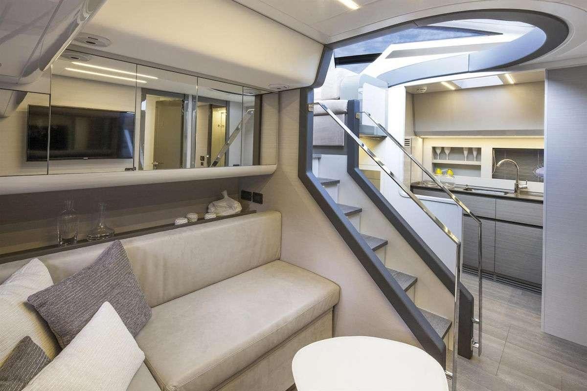 a room with a couch and a table aboard VELOCITY Yacht for Charter