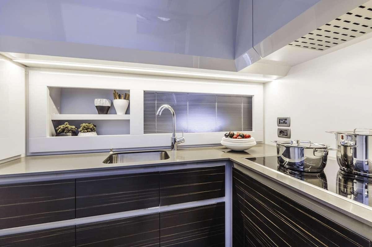 a kitchen with black counter tops aboard VELOCITY Yacht for Charter