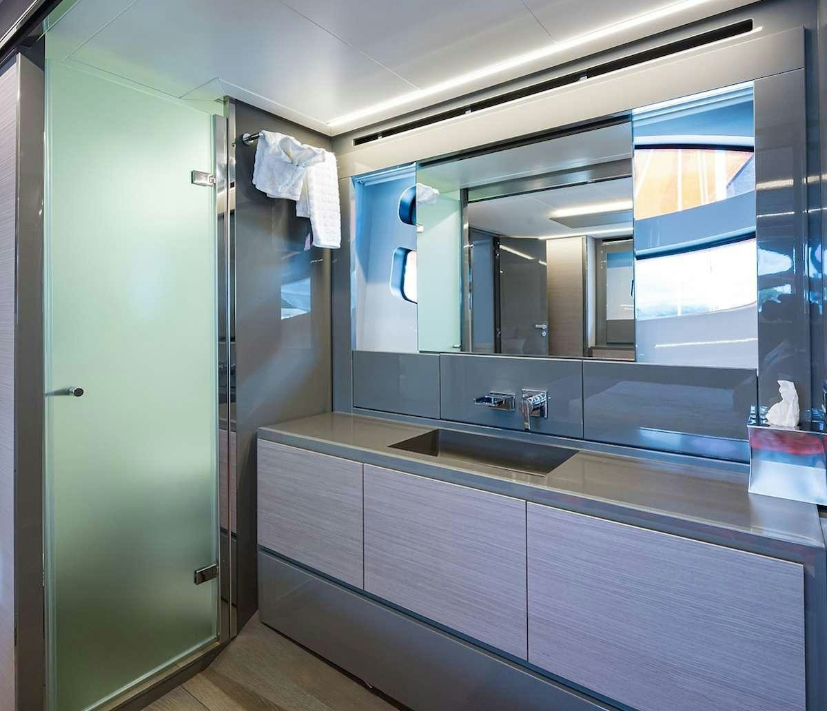 a bathroom with a large mirror aboard VELOCITY Yacht for Charter