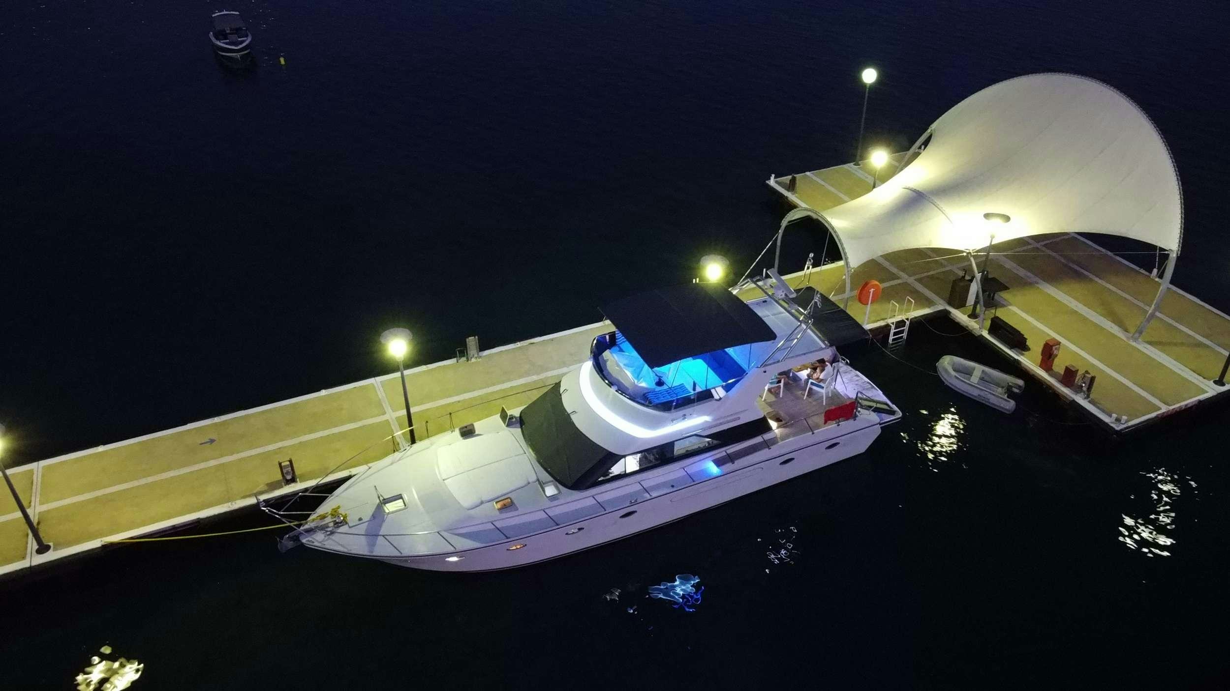 a white boat on a black surface aboard Marios L Yacht for Charter