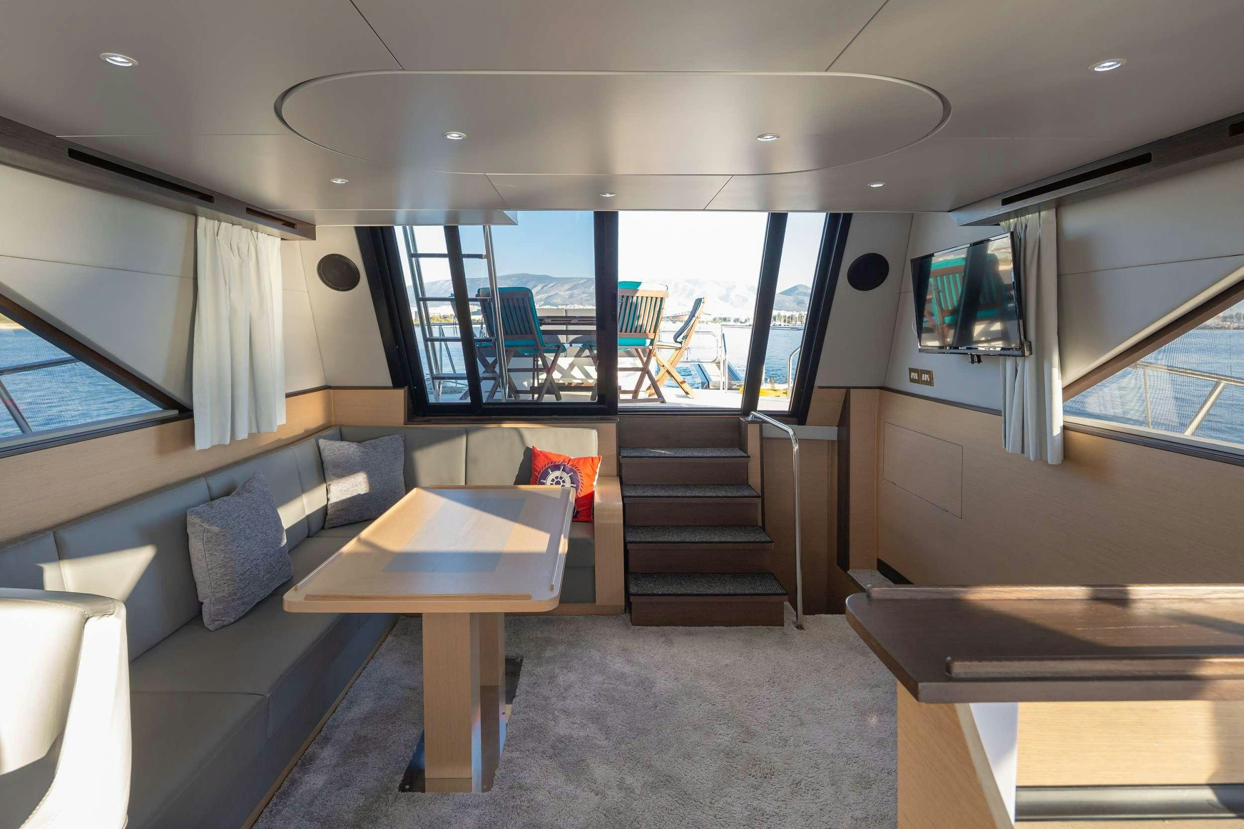a room with a table and chairs aboard Marios L Yacht for Charter