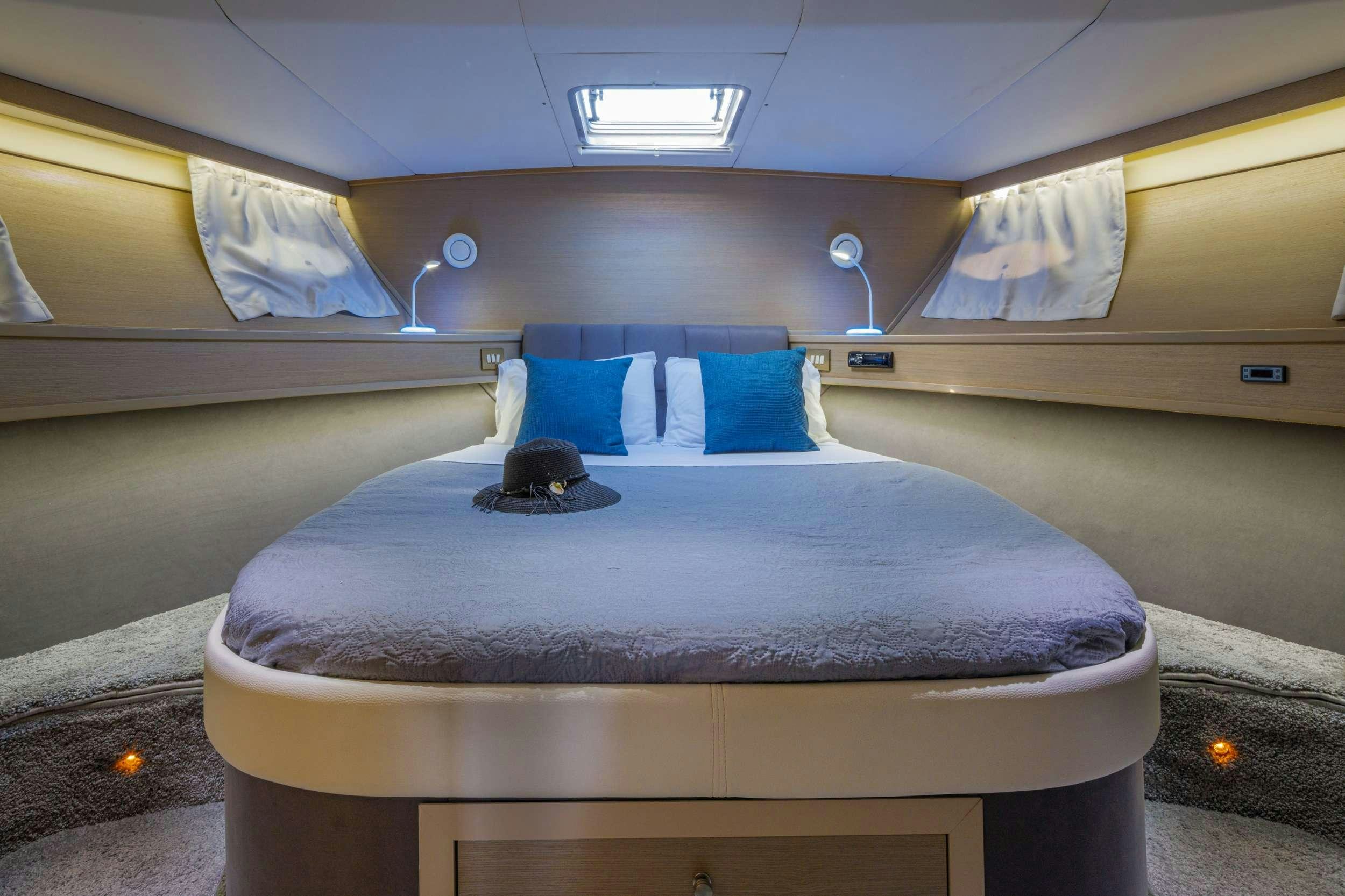 a bed in a room aboard Marios L Yacht for Charter