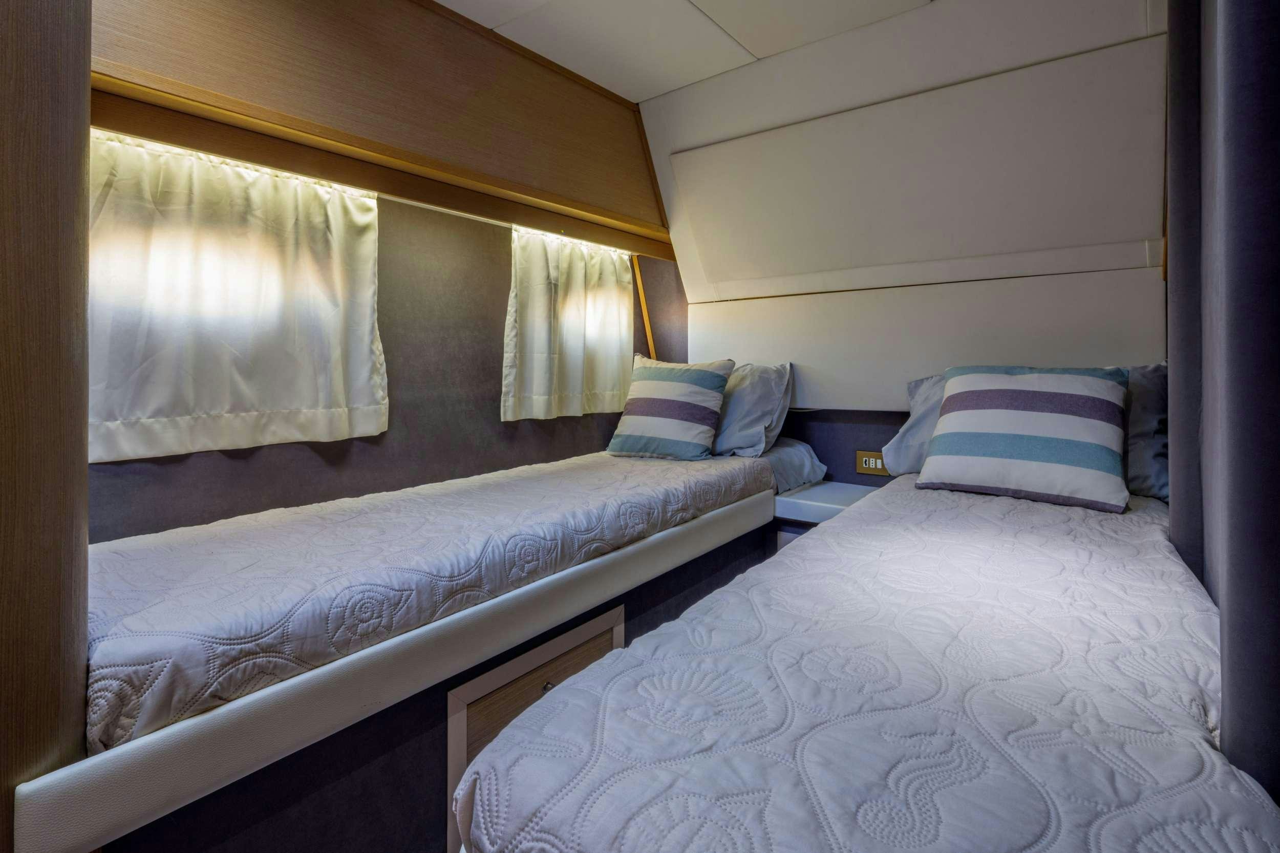 a couple of beds in a room aboard Marios L Yacht for Charter
