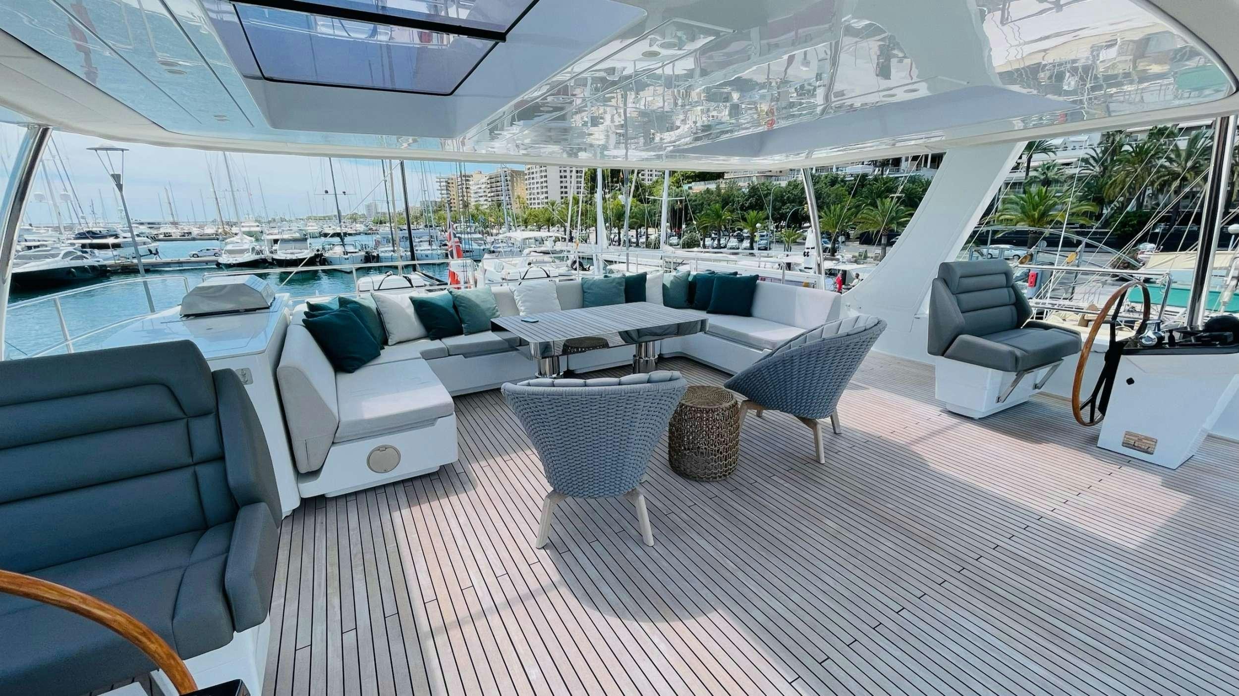 a large lounge area with a large white lounge chair and a large white lounge chair with a large aboard SEACLUSION Yacht for Charter