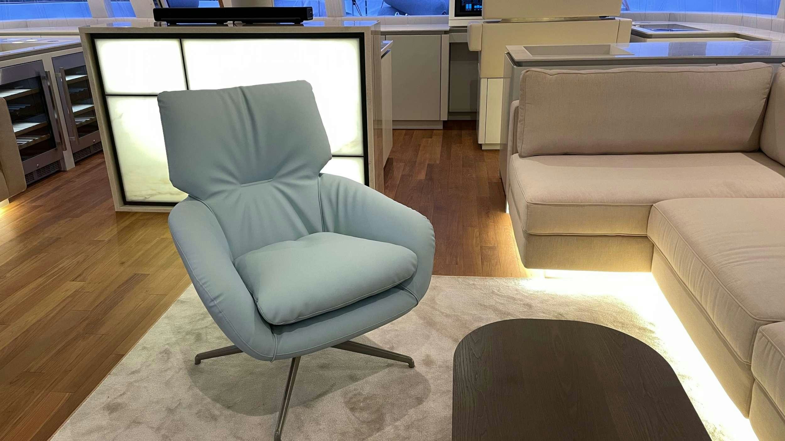 a chair in front of a couch aboard SEACLUSION Yacht for Charter