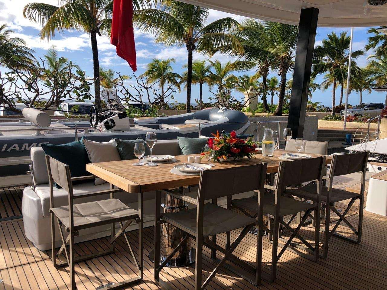 a patio with a pool and lounge chairs aboard SEACLUSION Yacht for Charter
