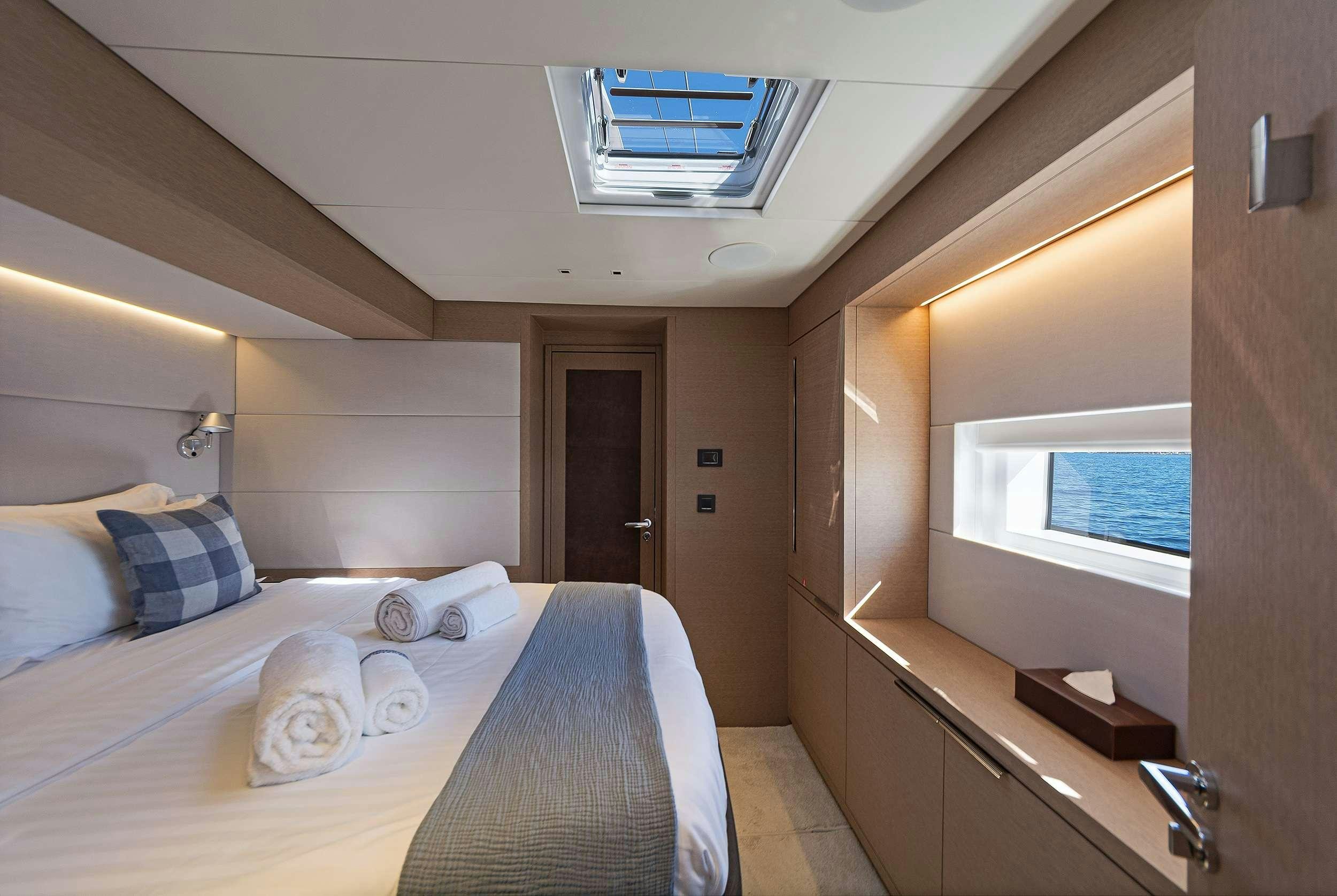 a bedroom with a bed and a window aboard DAIQUIRI Yacht for Charter
