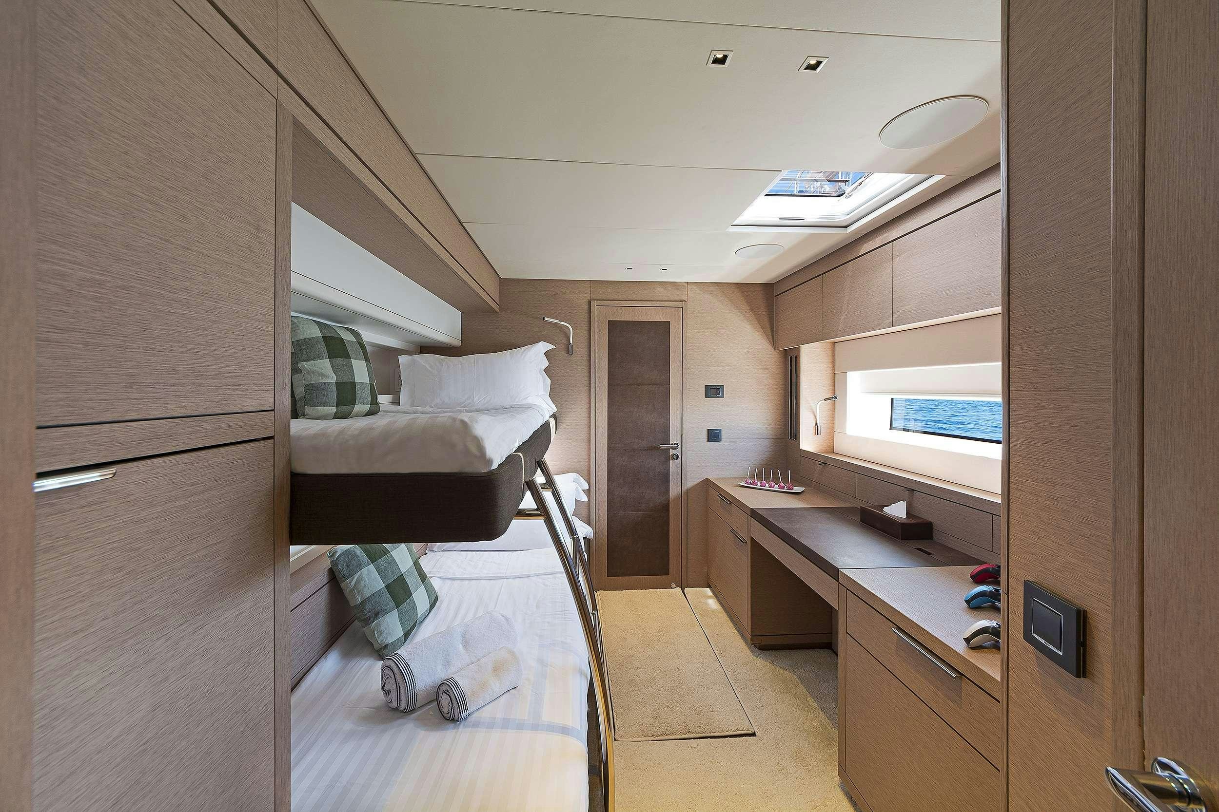 a room with a bed and desk aboard DAIQUIRI Yacht for Charter