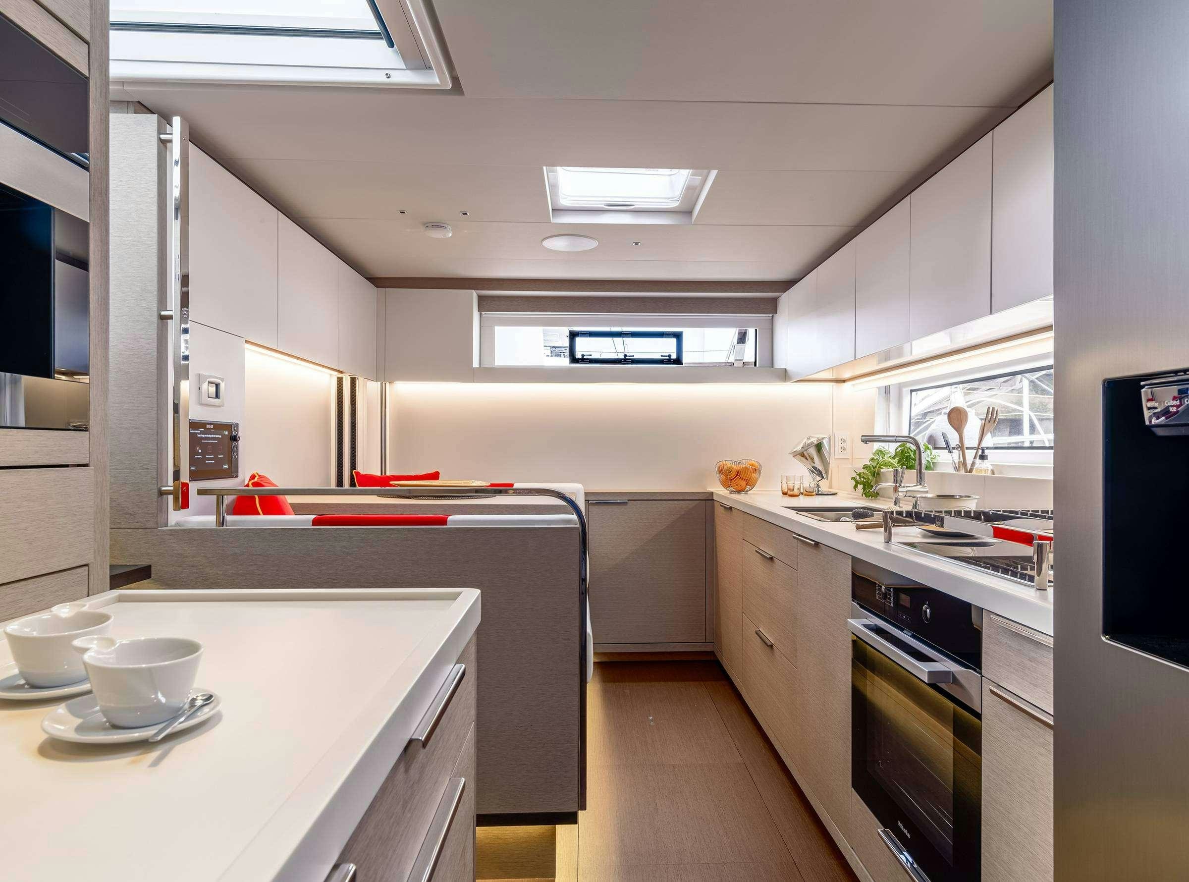 a kitchen with a red counter aboard DAIQUIRI Yacht for Charter