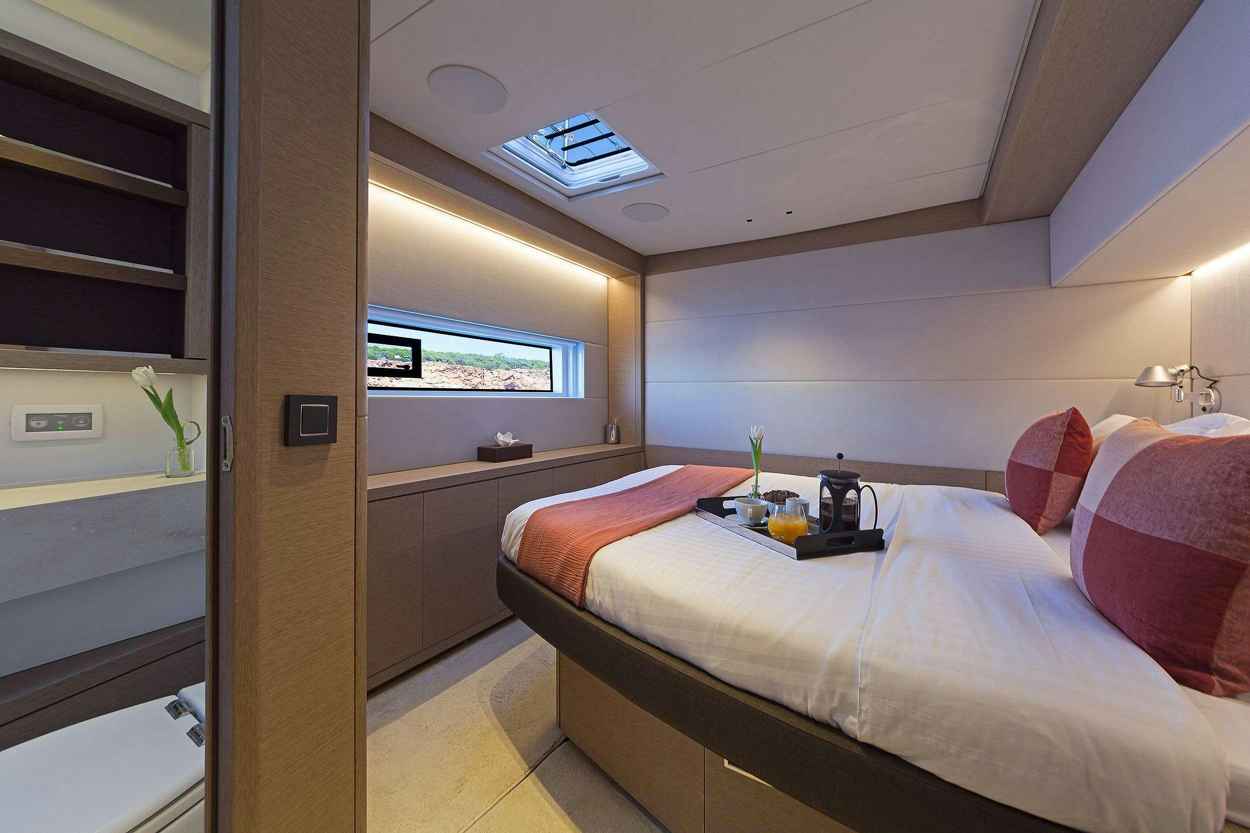 a room with a bed and a desk aboard DAIQUIRI Yacht for Charter