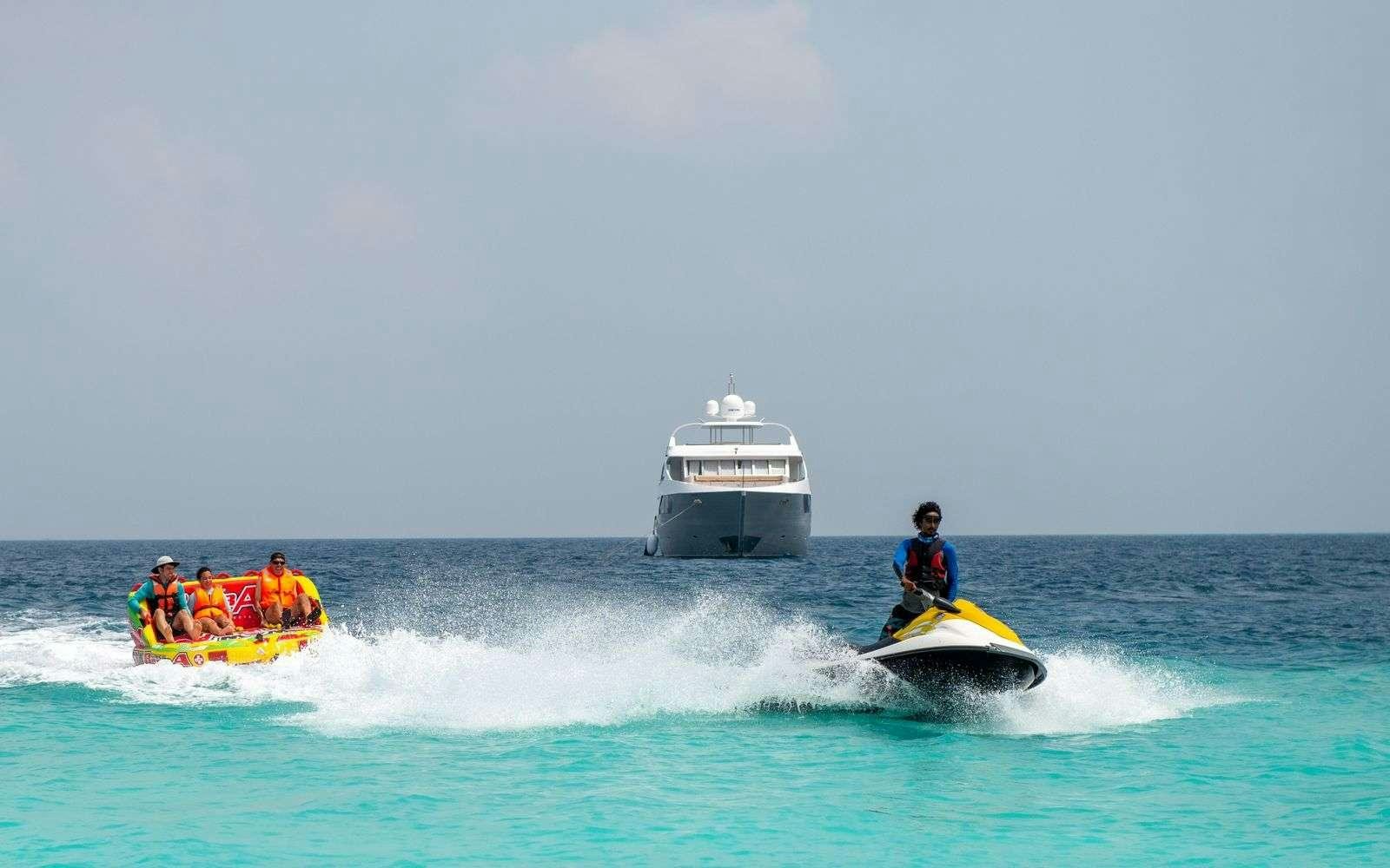 a boat and a group of people in the water aboard ARK NOBLE Yacht for Charter