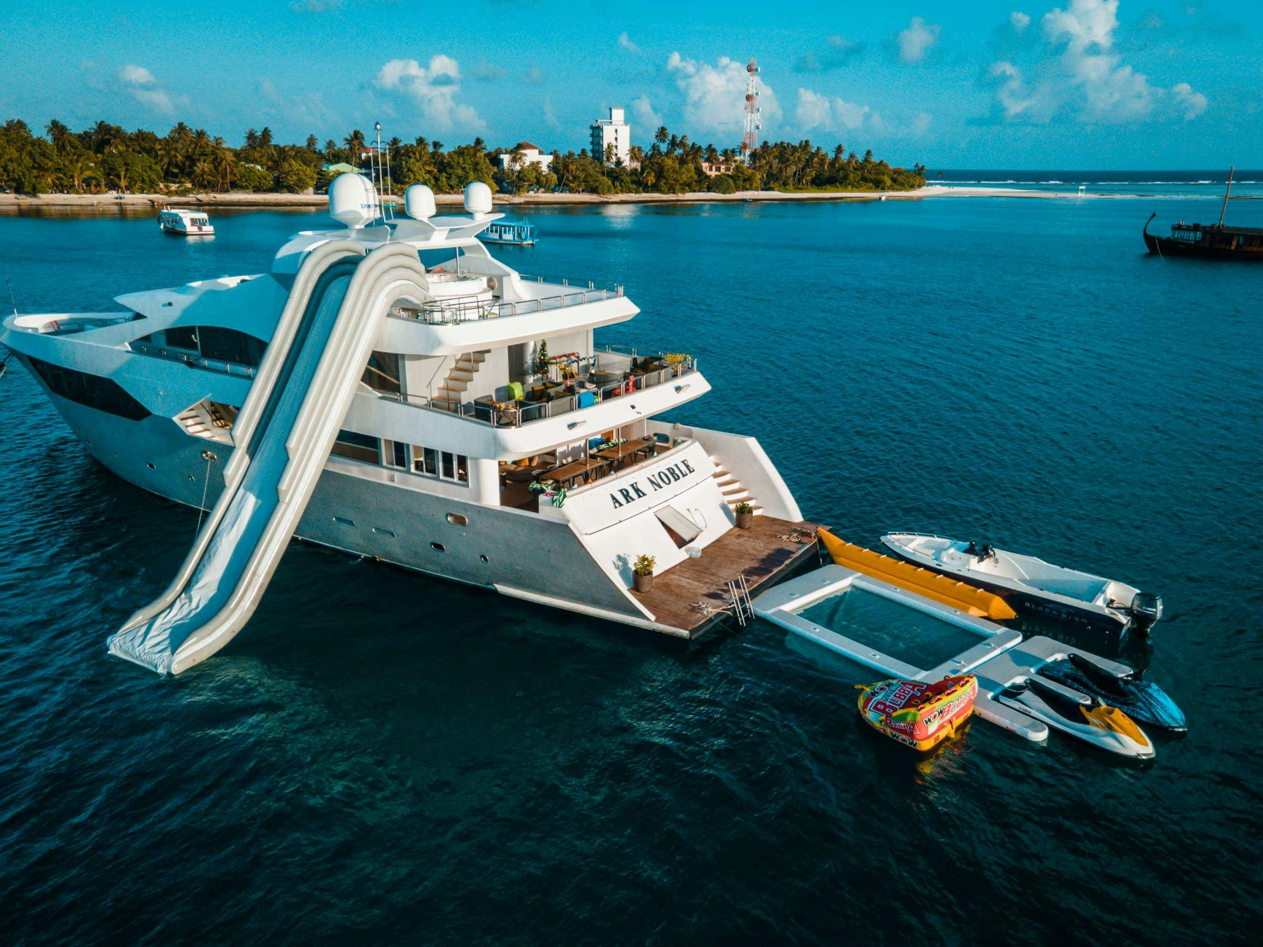 a large white boat on the water aboard ARK NOBLE Yacht for Charter