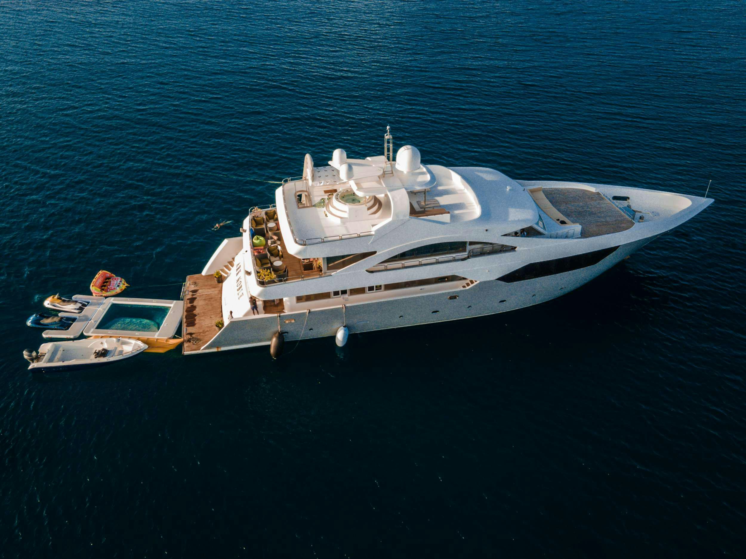 a boat with a lot of boats on the water aboard ARK NOBLE Yacht for Charter