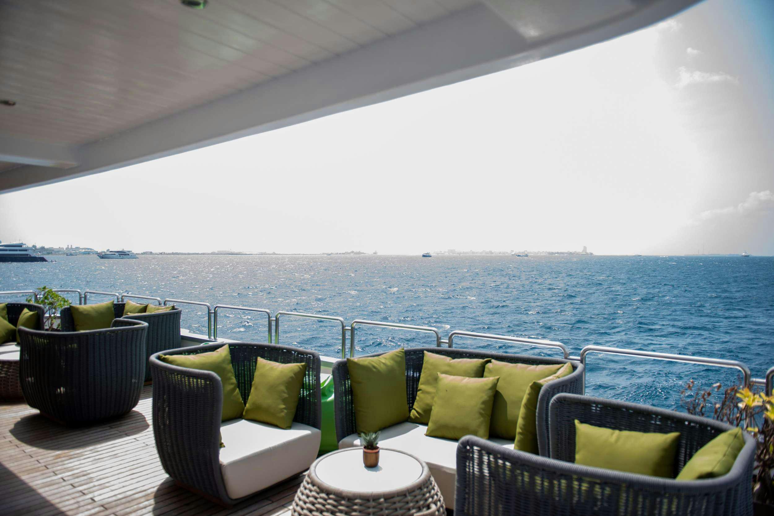 a balcony with a view of the ocean and the ocean aboard ARK NOBLE Yacht for Charter