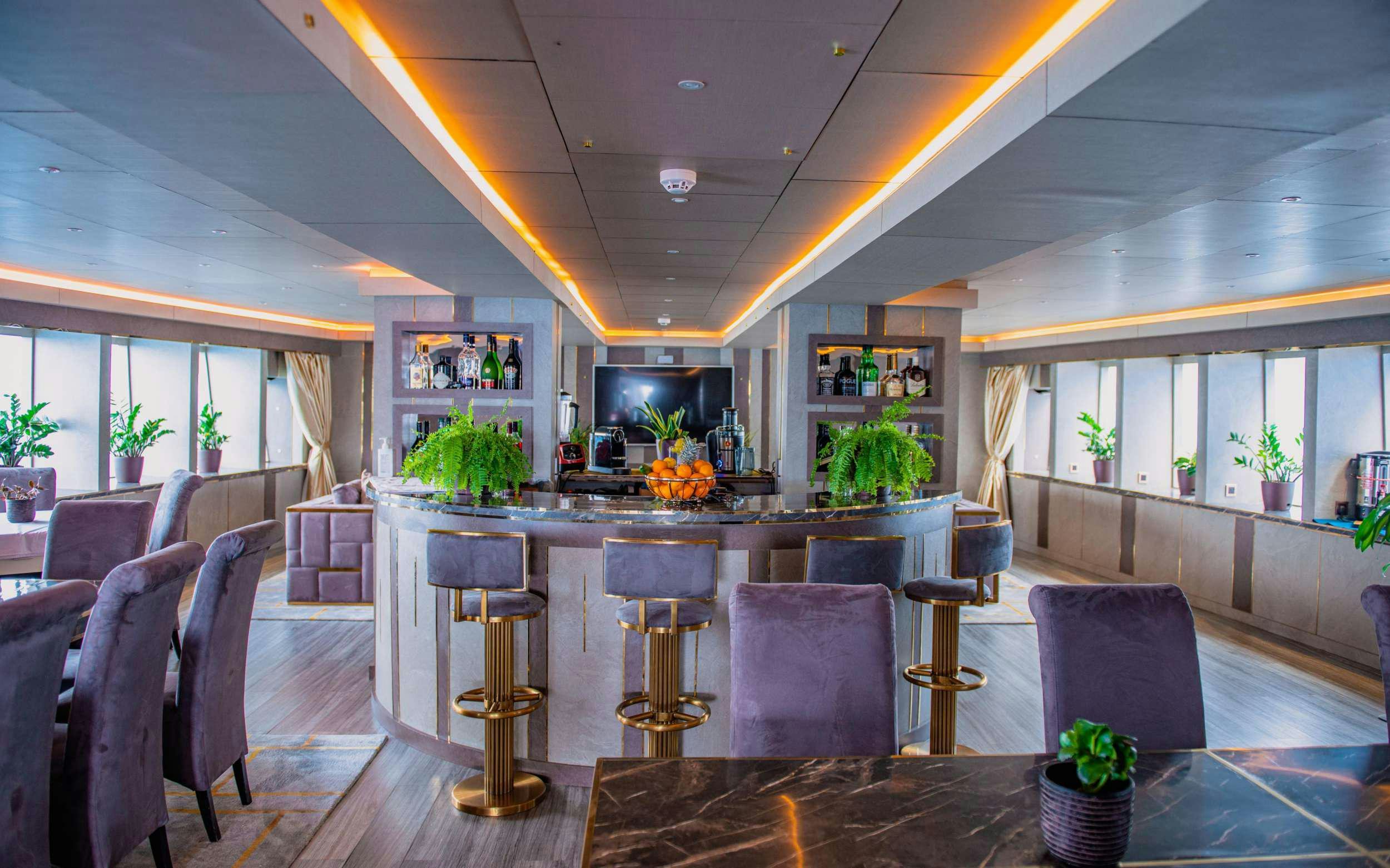 a large room with a table and chairs aboard ARK NOBLE Yacht for Charter