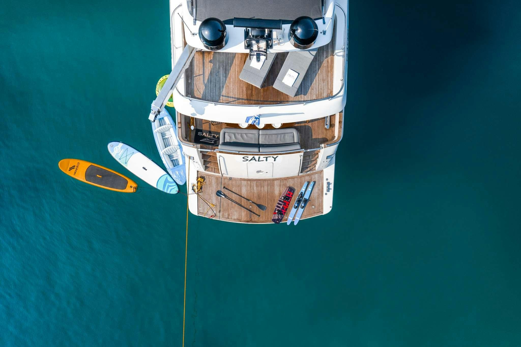 a boat with a paddle on the water aboard SALTY Yacht for Charter