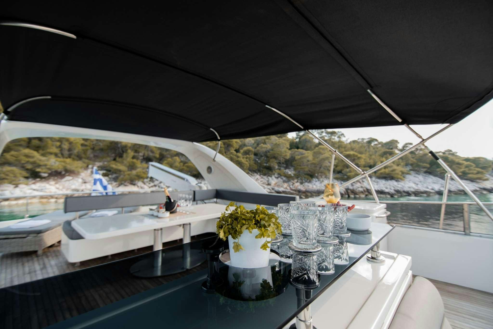 a table with glasses and flowers on it aboard SALTY Yacht for Charter