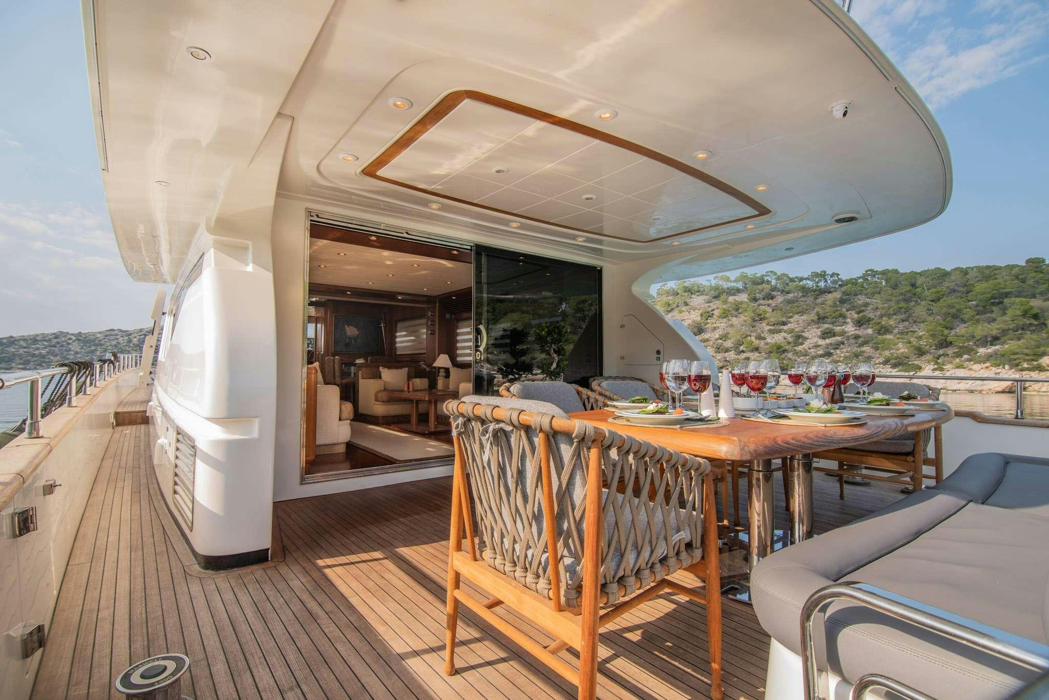 a deck with a table and chairs aboard SALTY Yacht for Charter