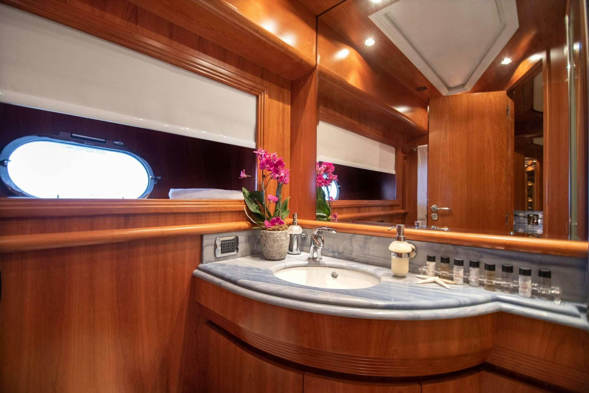 a bathroom with a sink and a window aboard SALTY Yacht for Charter