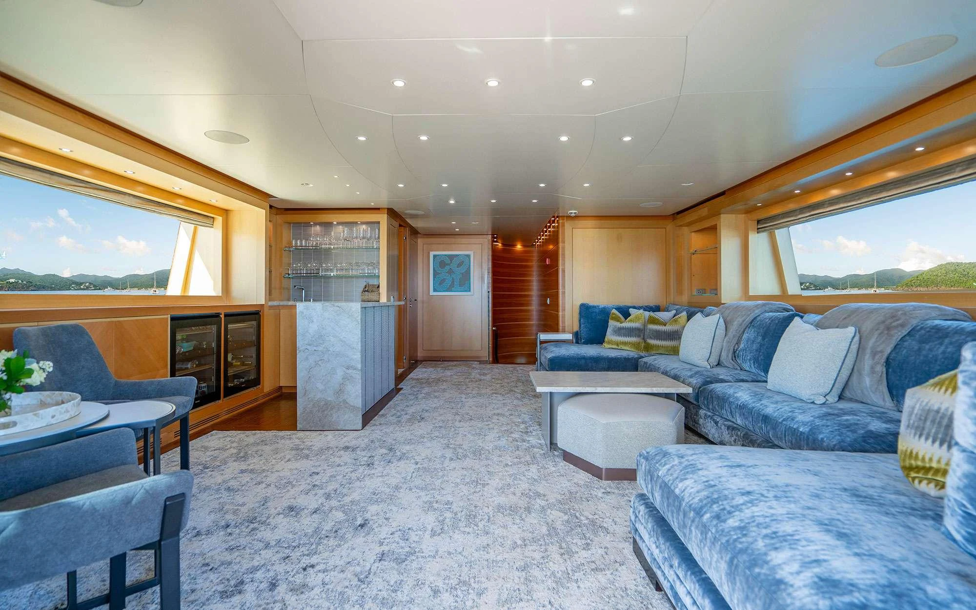 a living room with a large window aboard WHY NOT Yacht for Charter
