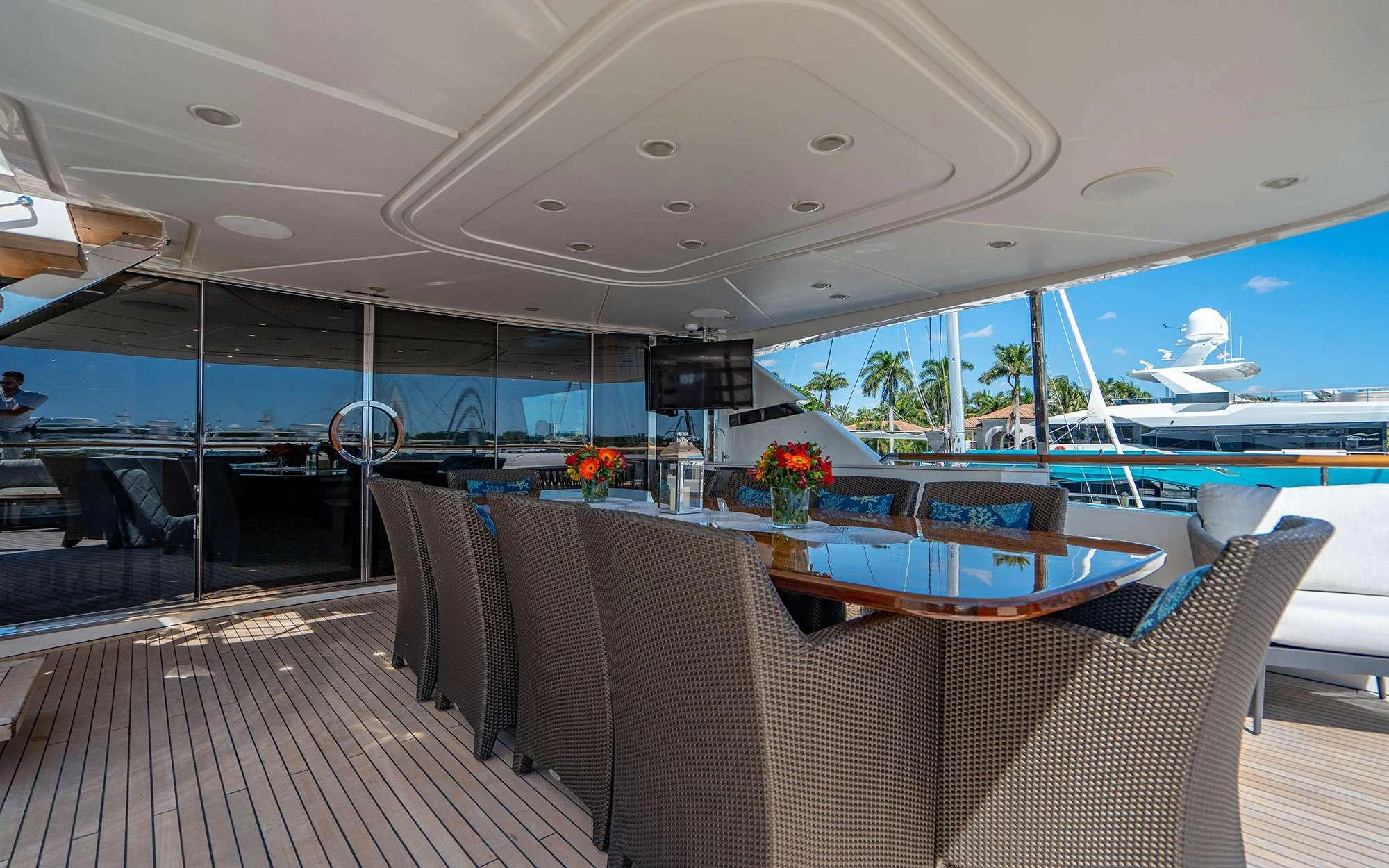 a large room with a table and chairs aboard WHY NOT Yacht for Charter