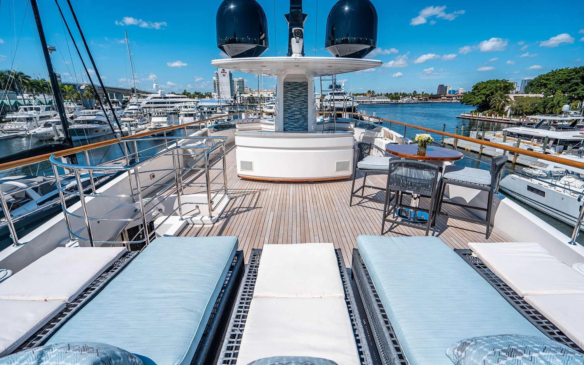 a deck with a deck and a view of a city aboard WHY NOT Yacht for Charter