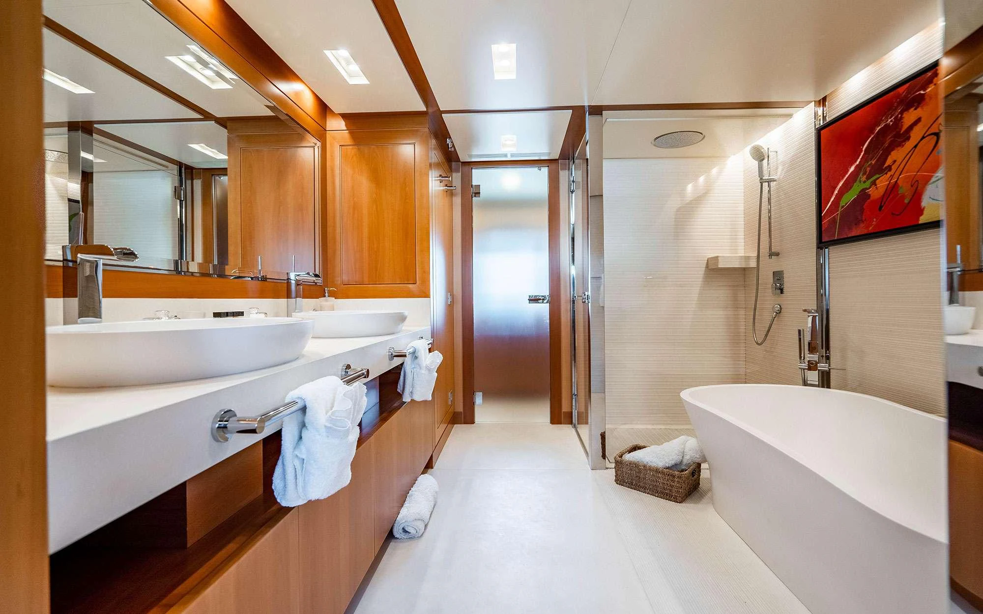 a bathroom with a bathtub and sinks aboard WHY NOT Yacht for Charter