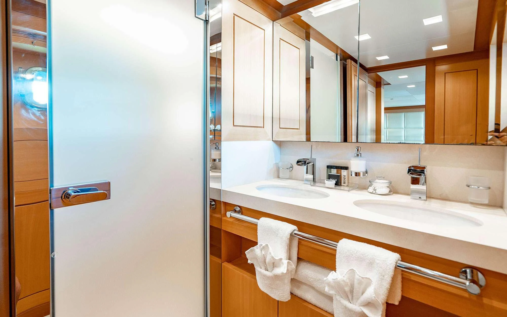 a bathroom with a large mirror aboard WHY NOT Yacht for Charter