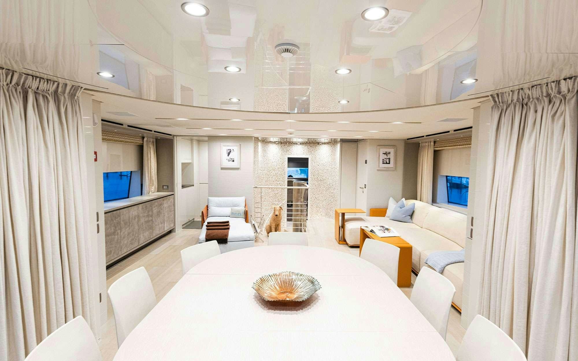 a large white room with a round table and a white table aboard HALCYON Yacht for Charter