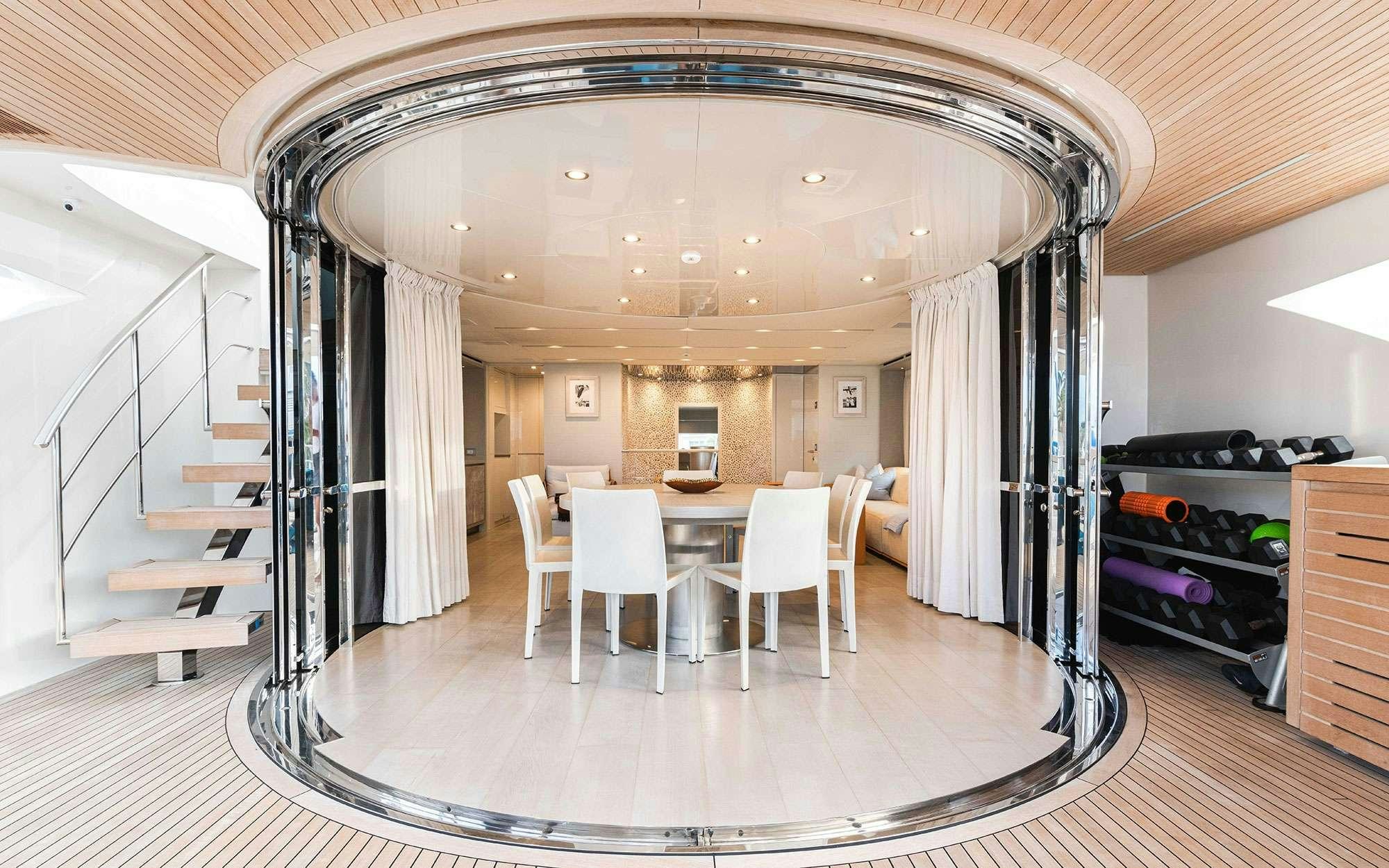 a large room with a table and chairs aboard HALCYON Yacht for Charter